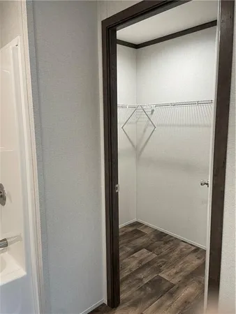 a view of storage and utility room with wooden floor