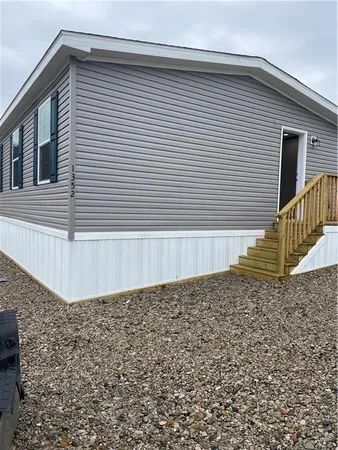 a view of a house with a wooden fence