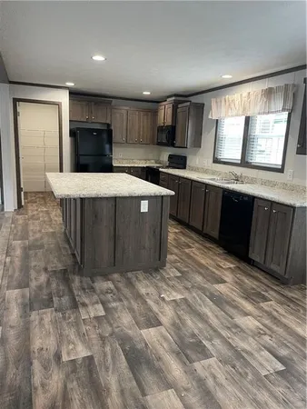 a kitchen with stainless steel appliances wooden cabinets a sink and a stove