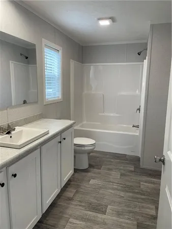 a bathroom with a double vanity sink toilet and shower