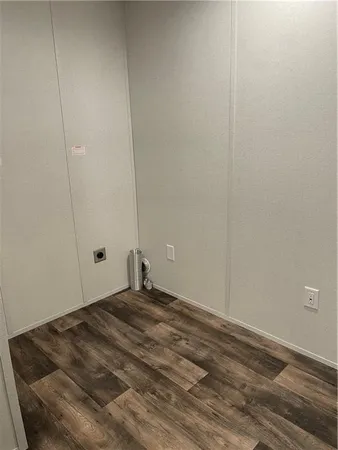 a view of a room with wooden floor