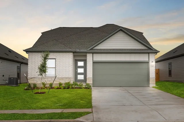 a front view of house with a garden