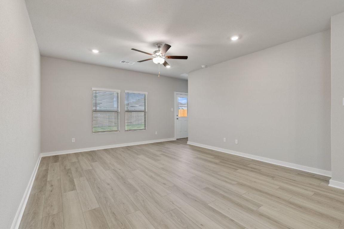 212 Lazy Lizzy Road Jarrell, TX 76537 - Photo 11 of 30 wooden floor in an empty room with a window