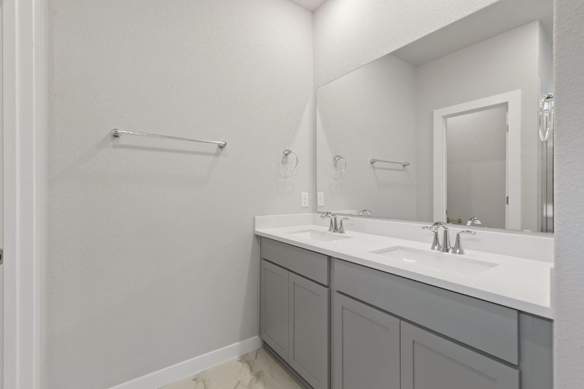 212 Lazy Lizzy Road Jarrell, TX 76537 - Photo 17 of 30 a bathroom with a sink and a mirror