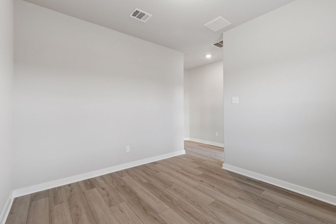 212 Lazy Lizzy Road Jarrell, TX 76537 - Photo 24 of 30 a view of an empty room with wooden floor