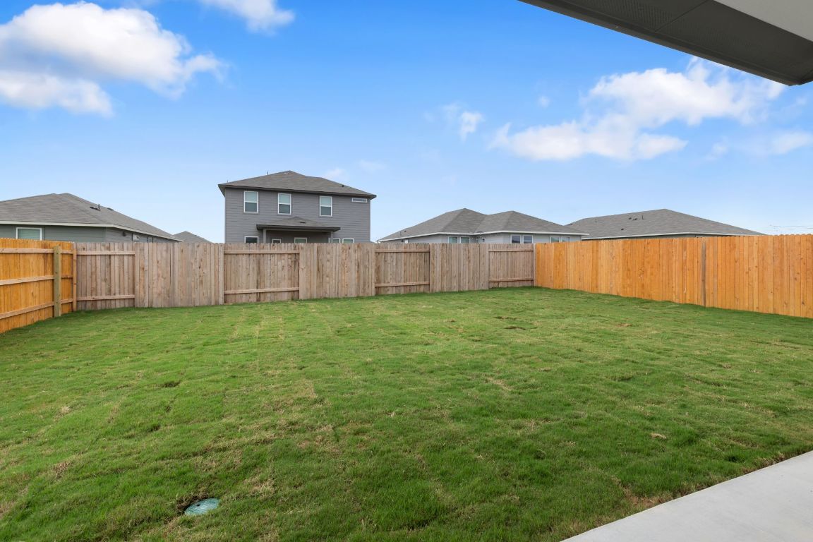 212 Lazy Lizzy Road Jarrell, TX 76537 - Photo 25 of 30 a view of a backyard with a garden