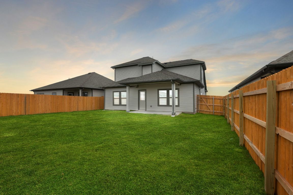 212 Lazy Lizzy Road Jarrell, TX 76537 - Photo 26 of 30 a backyard of a house with lots of green space
