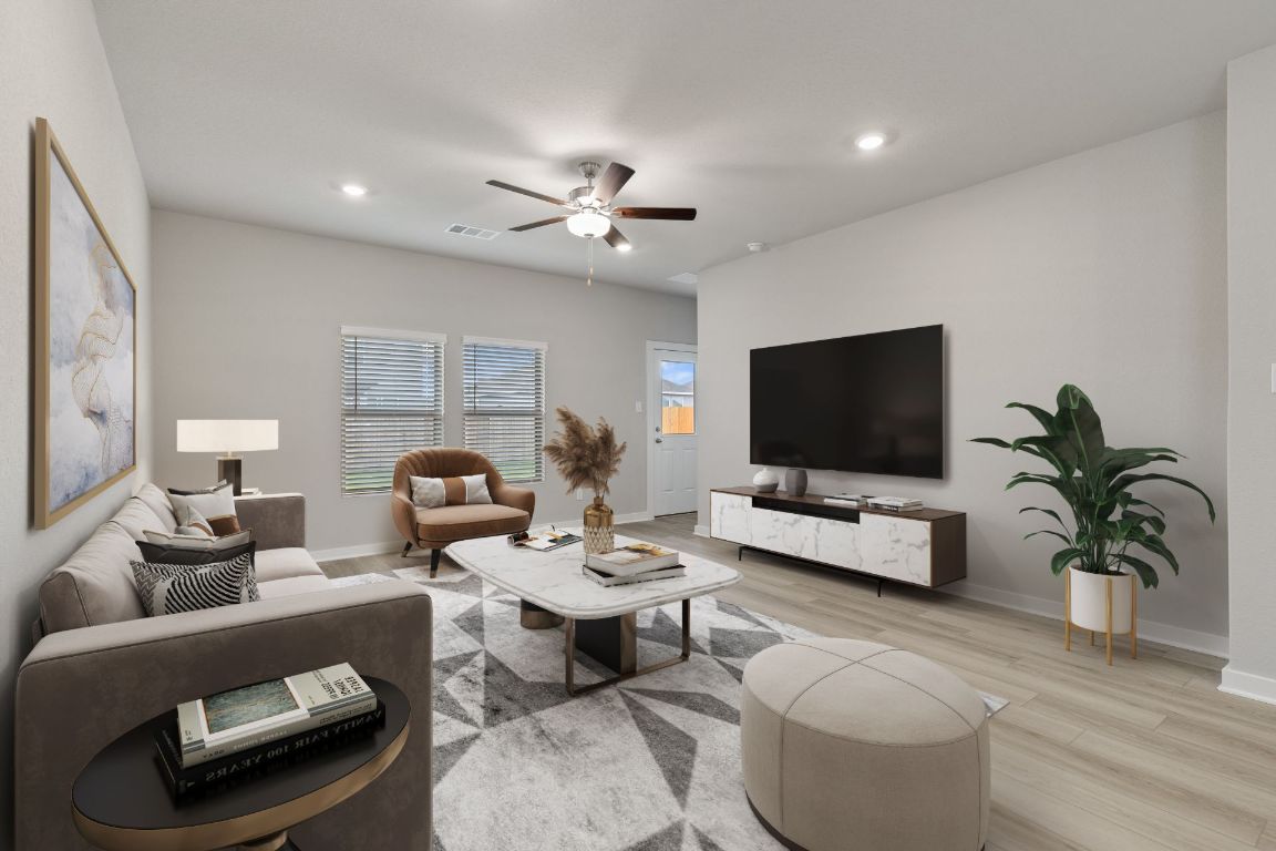 212 Lazy Lizzy Road Jarrell, TX 76537 - Photo 4 of 30 a living room with furniture a flat screen tv and a potted plant