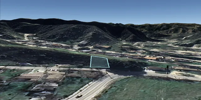 a view of a backyard with wooden fence