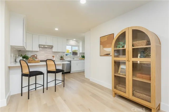 a living room with stainless steel appliances kitchen island granite countertop furniture and a kitchen view