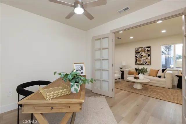 a living room with furniture and a potted plant