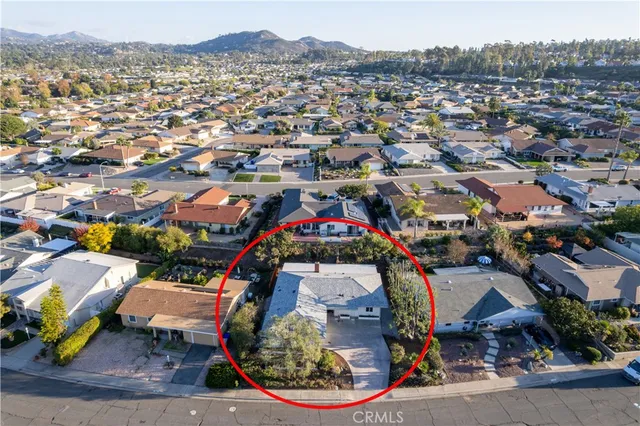 an aerial view of a houses with yard