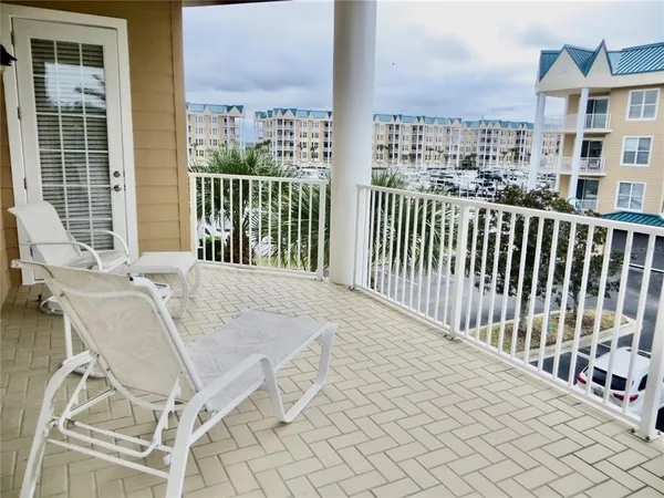 a balcony with table and chairs