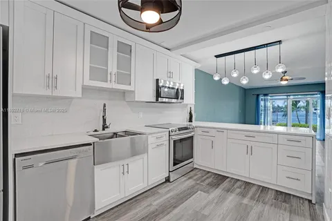 a kitchen with cabinets oven and a dishwasher
