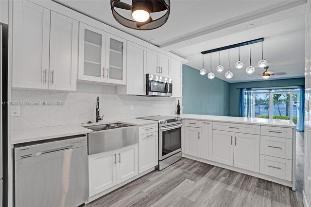 a kitchen with cabinets oven and a dishwasher