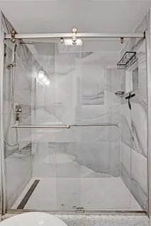 a view of a hallway with wooden floor and a potted plant