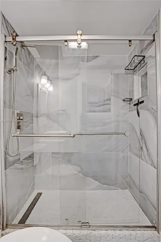 a view of a hallway with wooden floor and a potted plant