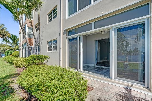 a view of a swimming pool with a patio and a yard