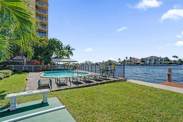 a view of a swimming pool with a garden and plants