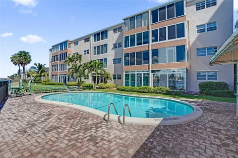 a view of a swimming pool with sitting area