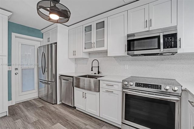 a kitchen with a sink and a refrigerator