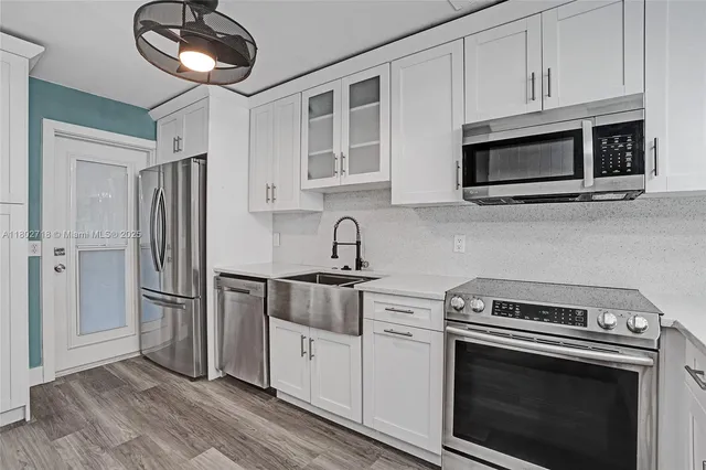 a kitchen with a sink and a refrigerator