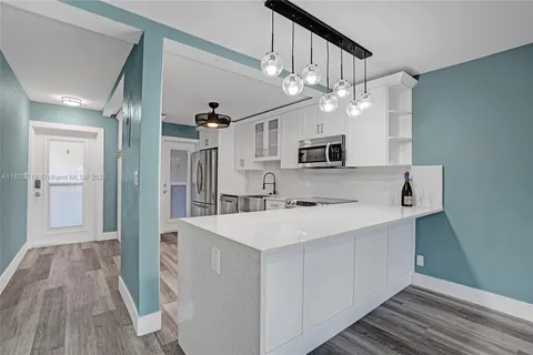 a view of a kitchen from a hallway