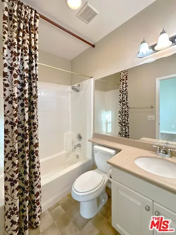 a bathroom with a sink a toilet a bathtub a mirror and shower