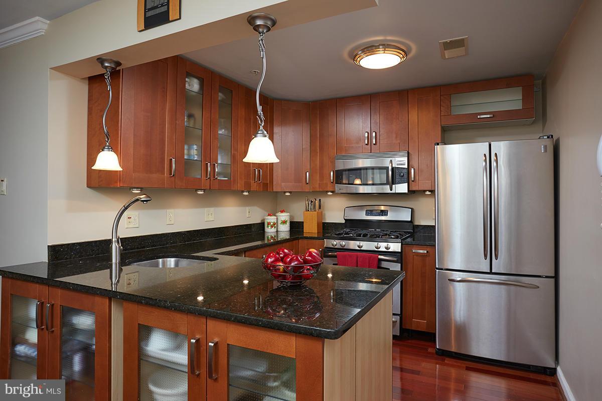 115 Timberbrook Lane, Unit 104 Gaithersburg, MD 20878 - Photo 1 of 28 a kitchen with a sink appliances and cabinets