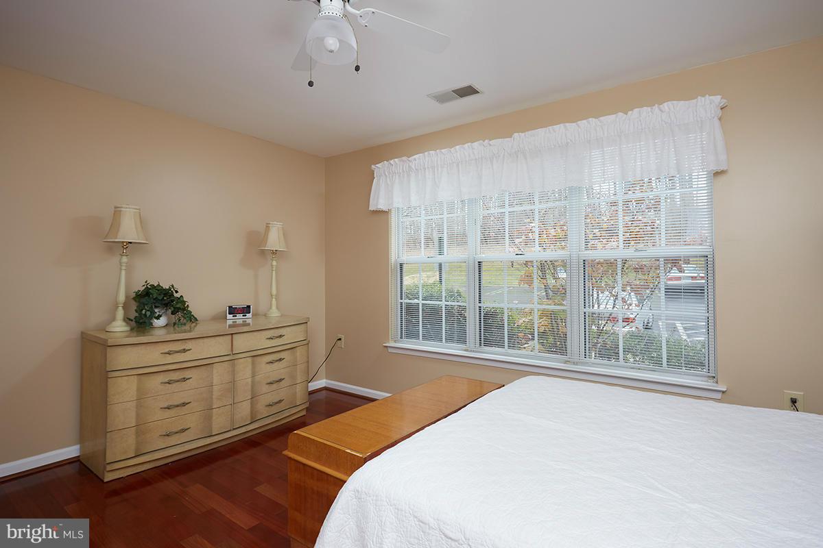 115 Timberbrook Lane, Unit 104 Gaithersburg, MD 20878 - Photo 11 of 28 a bedroom with a bed and a window