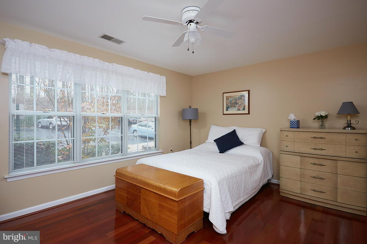 115 Timberbrook Lane, Unit 104 Gaithersburg, MD 20878 - Photo 13 of 28 a bedroom with a bed and window