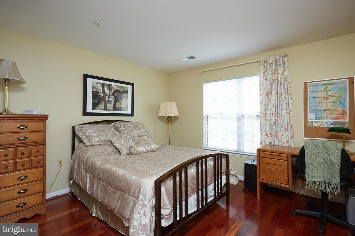 115 Timberbrook Lane, Unit 104 Gaithersburg, MD 20878 - Photo 16 of 28 a bedroom with furniture and a window