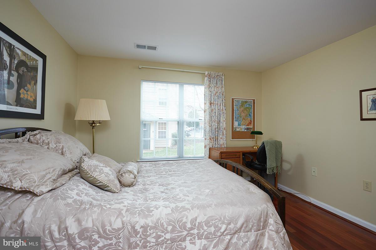 115 Timberbrook Lane, Unit 104 Gaithersburg, MD 20878 - Photo 17 of 28 a bedroom with a bed and a window