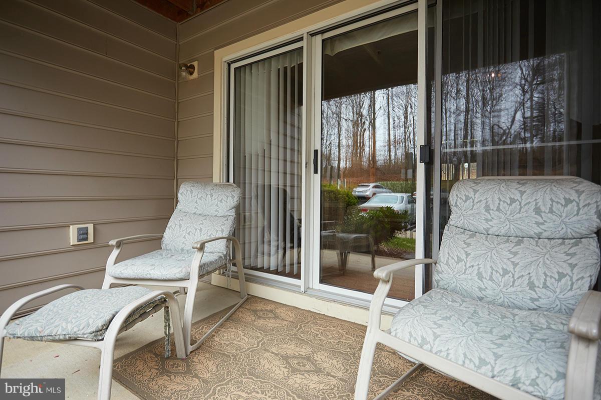 115 Timberbrook Lane, Unit 104 Gaithersburg, MD 20878 - Photo 20 of 28 a building outdoor space with patio furniture and potted plants