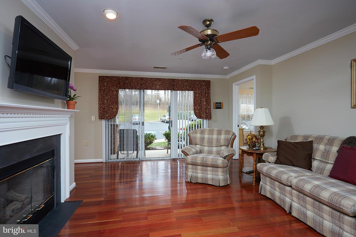 115 Timberbrook Lane, Unit 104 Gaithersburg, MD 20878 - Photo 3 of 28 a living room with furniture fireplace and flat screen tv