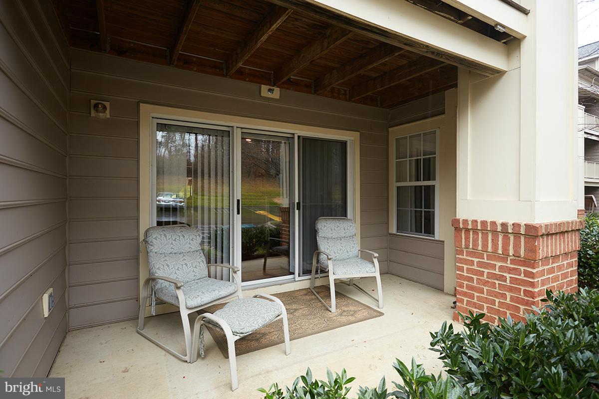 115 Timberbrook Lane, Unit 104 Gaithersburg, MD 20878 - Photo 21 of 28 a balcony with table and chairs