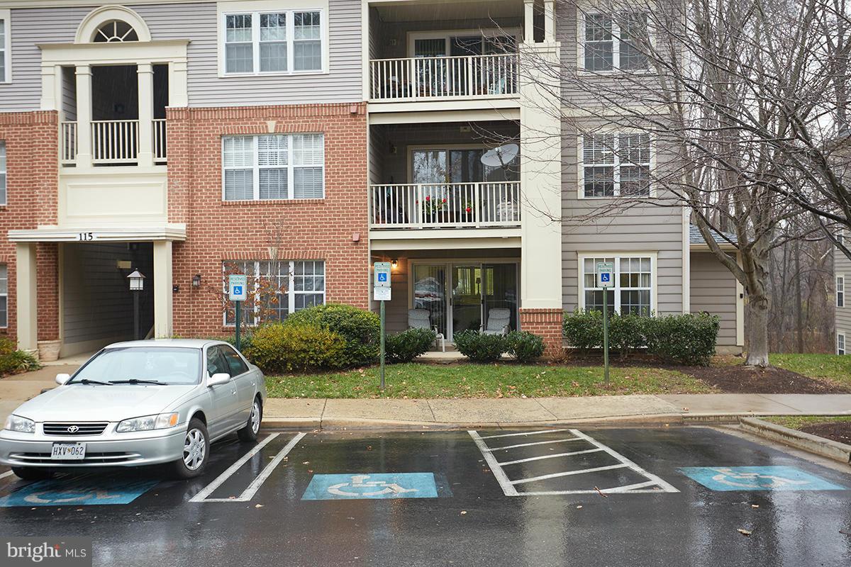 115 Timberbrook Lane, Unit 104 Gaithersburg, MD 20878 - Photo 23 of 28 a car parked in front of a brick house