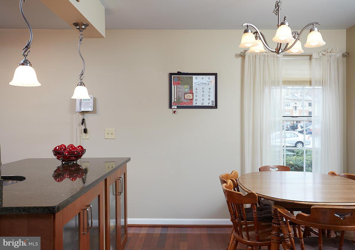 115 Timberbrook Lane, Unit 104 Gaithersburg, MD 20878 - Photo 9 of 28 a view of a dining room with furniture and wooden floor