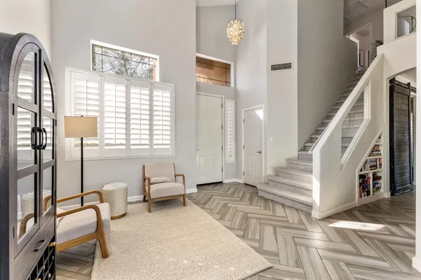 a dining hall with stainless steel appliances granite countertop a stove a sink dishwasher and a dining table with wooden floor