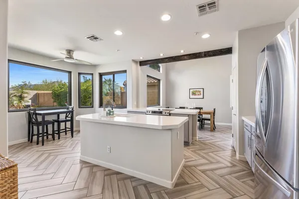 a large kitchen with kitchen island a sink counter space appliances and a living room view