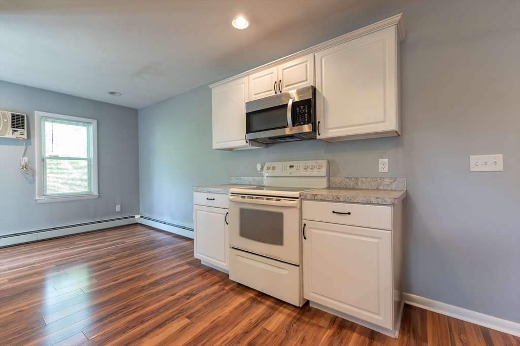 2 Raymond Street North Smithfield, RI 02896 - Photo 2 of 18 a kitchen with stainless steel appliances white cabinets and a stove top oven