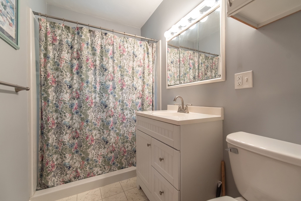2 Raymond Street North Smithfield, RI 02896 - Photo 8 of 18 a bathroom with a sink toilet and window