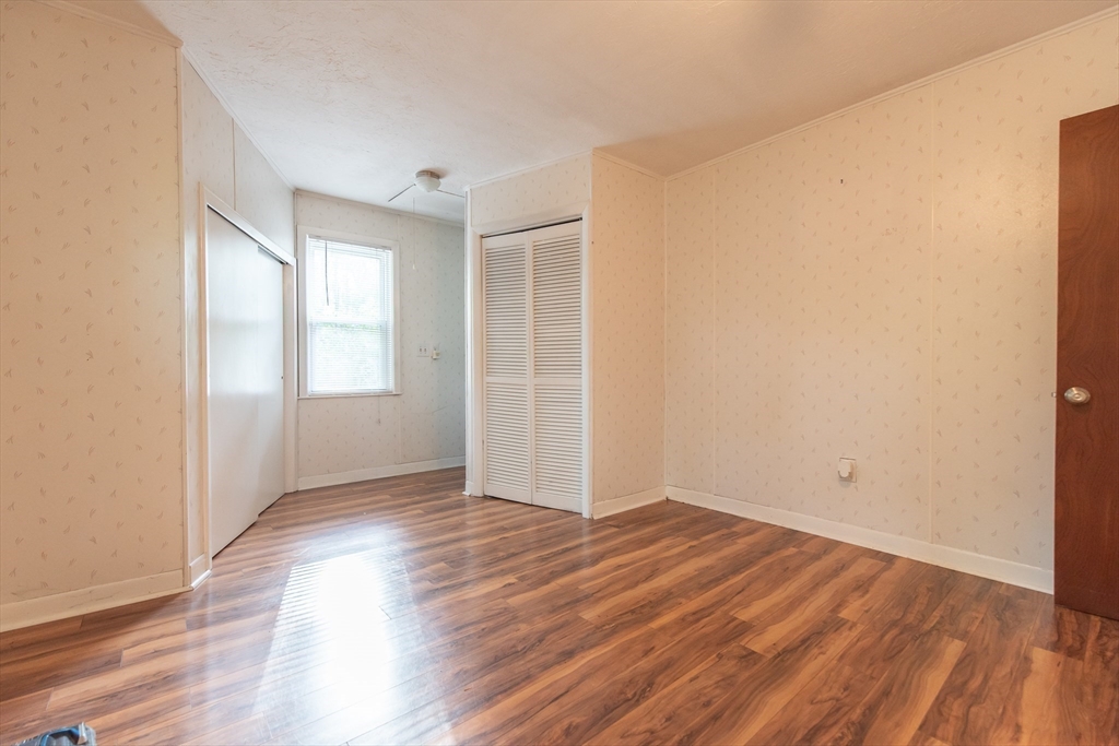2 Raymond Street North Smithfield, RI 02896 - Photo 10 of 18 an empty room with wooden floor and windows