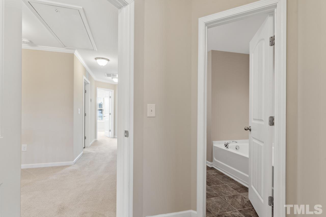 7705 Weathered Oak Way Raleigh, NC 27616 - Photo 14 of 26 a bathroom with a sink and a mirror