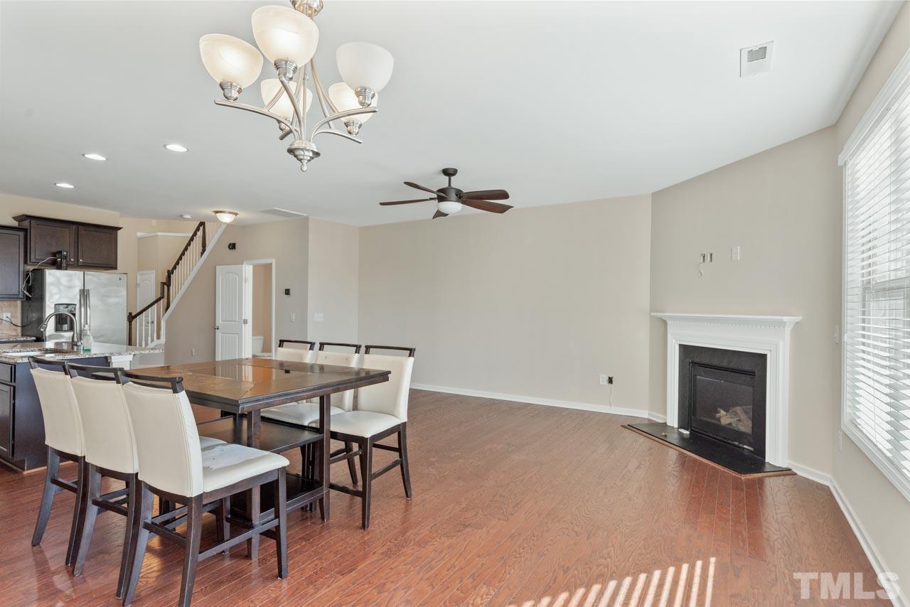 7705 Weathered Oak Way Raleigh, NC 27616 - Photo 8 of 26 a view of a dining room with furniture wooden floor and chandelier