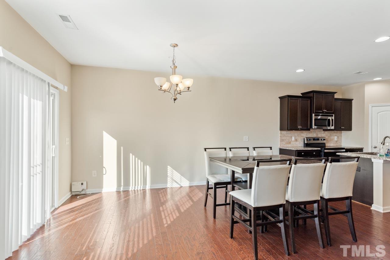 7705 Weathered Oak Way Raleigh, NC 27616 - Photo 9 of 26 a view of a dining room with furniture and wooden floor