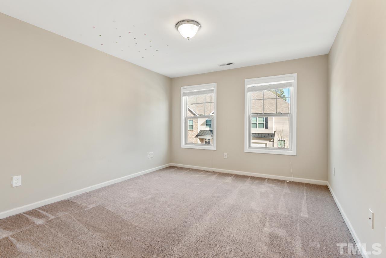 7705 Weathered Oak Way Raleigh, NC 27616 - Photo 10 of 26 an empty room with windows