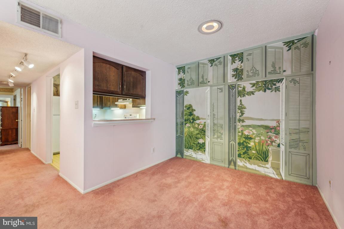 25 Church Road, Unit 150 Maple Shade, NJ 08052 - Photo 11 of 22 a view of a hallway with wooden floor and a living room