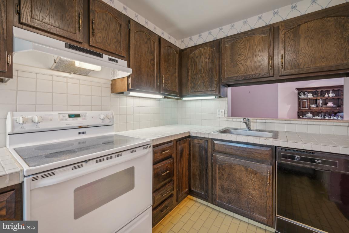 25 Church Road, Unit 150 Maple Shade, NJ 08052 - Photo 15 of 22 a kitchen with a sink stove and cabinets