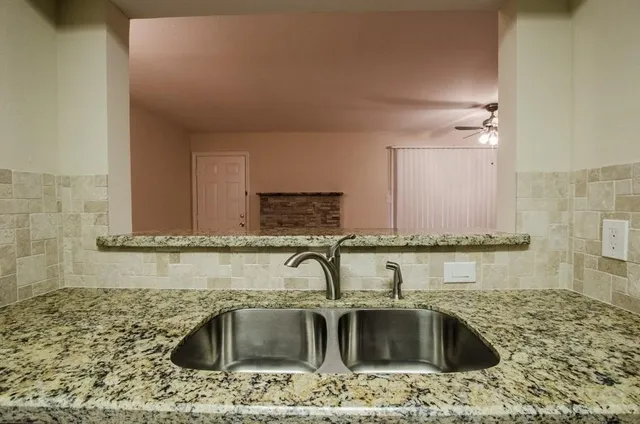 a kitchen with a sink cabinets and granite counter top